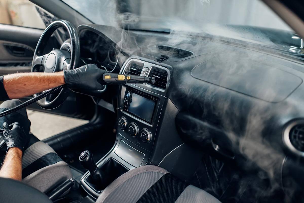 Cleaning vents and dashboard with steam cleaner brush