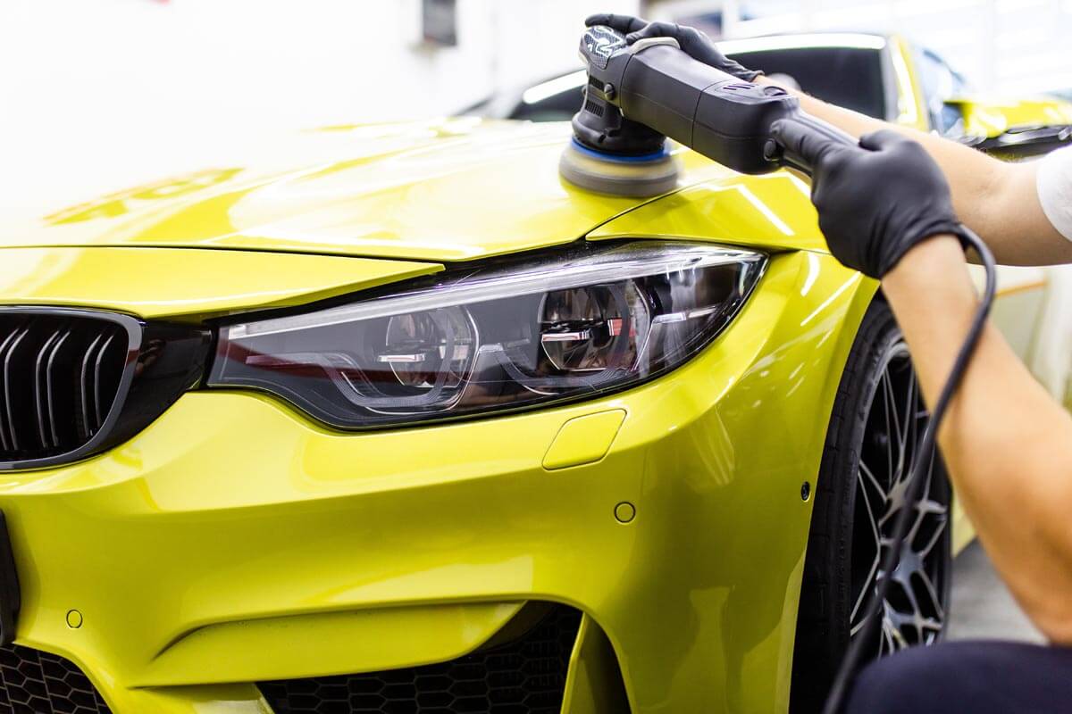 Polishing yellow BMW M3 using a Rupes polisher